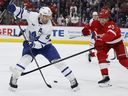 Maple Leafs’ John Tavares slides a no-look pass between his legs against Red Wings defenceman Moritz Seider earlier this season.