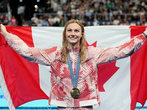 Canada's Summer McIntosh, of Toronto, celebrates with her gold medal won in the 200m women's individual medley final during the 2024 Summer Olympic Games, in Nanterre, France, Saturday, Aug. 3, 2024.