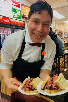 Bahran Rahmany serves up famous Montreal smoked meat sandwiches on rye at Schwartz's in Montreal.
