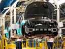 Workers on an assembly line at the Honda plant in Alliston, Ont., are pictured on April 25, 2024.