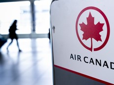 A passenger walks past the Air Canada check-in counter