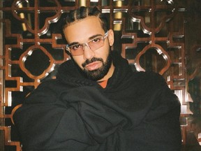 Rapper Drake posing with arms crossed.