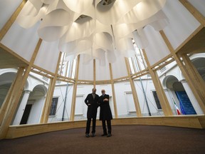 Grande Brera Museum director, Angelo Crespi, right, poses flanked by designer Mario Cucinella inside a wooden temple, at Palazzo Citterio Museum in Milan, Italy, Saturday Dec. 7, 2024.