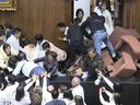 In this image produced by Taiwan’s EBC’s video, legislators of the Democratic Progressive Party and members of the Nationalist Party or Kuomintang controls the Speaker’s Chairman on Friday, December 20, 2024 in the legislature in Taipei, Taiwan.