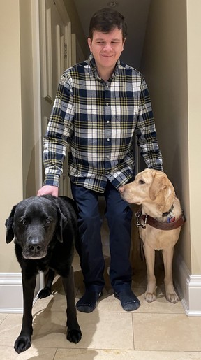 Robert Hampson at home with his dogs Spokane (L) and Kelly (R).