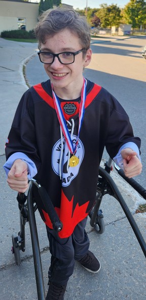 Zach Rayment, 15, with his medal after a Volt hockey tourney.