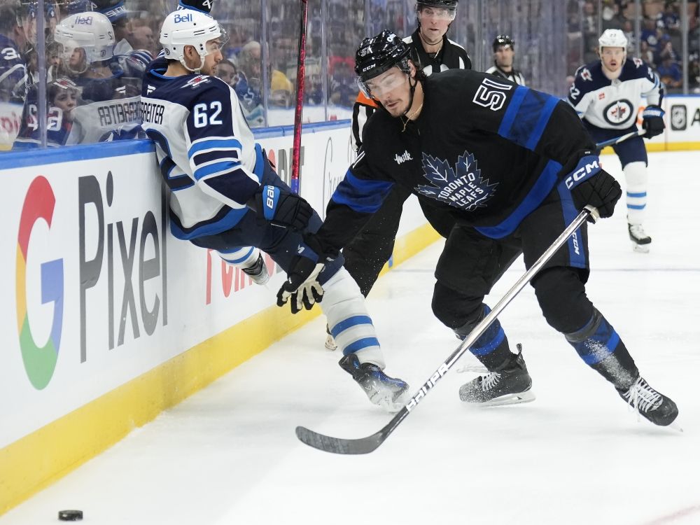 Toronto Maple Leafs defenceman Philippe Myers takes out Winnipeg Jets forward Nino Niederreiter.