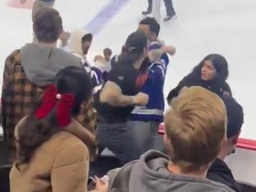 A man attacked two fans wearing Maple Leafs jerseys during Tuesday's game in Philadelphia.