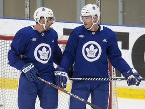 John Tavares (left) and Patrick Marleau (R) talk during at Toronto Maple Leafs practice in 2018.