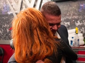 Becky Lynch hugs TJ Wilson.