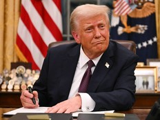 Donald Trump signing document at his desk