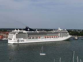 A MSC Magnifica cruise ship carried by three tugboats arriving in the Venice Lagoon.