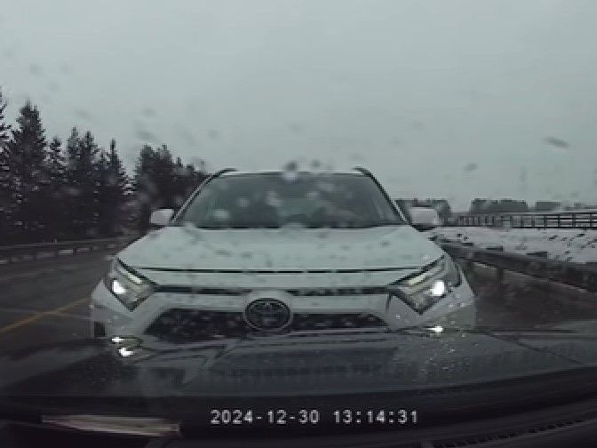 Dash cam video captured by a driver in Northern Ontario shows a white SUV ramming a vehicle on the shoulder of a highway on Dec. 30, 2024.