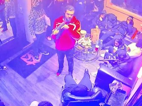 This screengrab from Toronto Police released Thursday, Jan. 23, 2025, shows a group of individuals holding firearms during a party in downtown Toronto on Nov. 11, 2024.