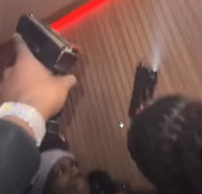 This screengrab from Toronto Police released Thursday, Jan. 23, 2025, shows a group of individuals holding firearms during a party in downtown Toronto on Nov. 11, 2024.