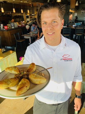 Lip Smacking Foodie Tours guide Trey Williamson at 7th & Carson, voted restaurant of the year in 2018 by the Nevada Restaurant Association, with a plate of lightly spiced curry pasties.