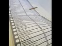 A photo of the comically large ballot used during the 2024 Toronto-St. Paul byelection.