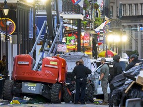 Police investigators surround a white truck