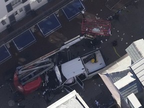 Investigators work the scene after a person drove a vehicle into a crowd earlier on Canal and Bourbon Street in New Orleans, Wednesday, Jan. 1, 2025.