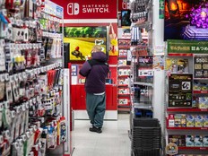 A man walks past shelves in the gaming section of Nintendo Switch products at a shop in Tokyo on Jan. 16, 2025.