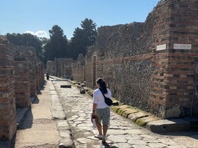 Walking along a stone street in Pompeii, Italy.