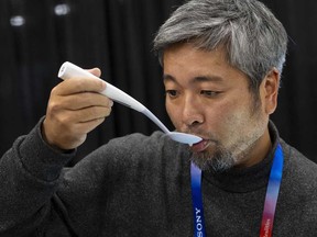 Kiyohiro Izumo uses the Kirin Electric Salt spoon which intensifies salt flavour by flowing a mild electric current through the food around the tongue to attract salt towards the tongue, during 2025 CES Unveiled, Sunday, Jan. 5, 2025, in Las Vegas.
