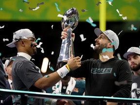 Jalen Hurts of the Philadelphia Eagles hands the Vince Lombardi Trophy to head coach Nick Sirianni after beating the Kansas City Chiefs to win the Super Bowl.
