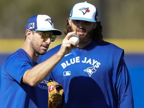 Toronto Blue Jays pitcher Max Scherzer, left, teaches a technique to Alek Manoah during spring training.