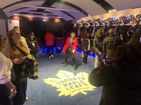 Fans take in the Maple Leafs dressing room during a tour of Scotiabank Arena.