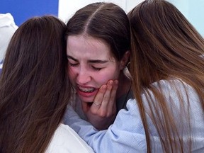 This handout picture released by the Israeli government press office (GPO) shows freed Israeli hostage Agam Berger (C) being welcomed by her family at the Beilinson hospital in Petah Tikva, near Tel Aviv after her release by Hamas in the Gaza Strip, on January 30, 2025. GPO/AFP via Getty Images