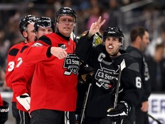 Dany Heatley and Justin Bieber gesture toward the crowd in L.A.