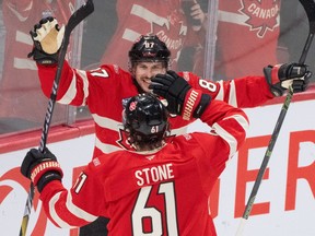 Canada forward Mark Stone (61) celebrates his goal over Sweden with teammate Sidney Crosby (87) during second period 4 Nations Face-Off hockey action in Montreal on Wednesday.