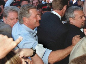 Ontario Premier Mike Harris makes his way through a crowd.