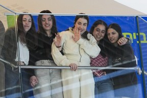 Five former Israeli hostages recently released from Hamas captivity, from right, Daniella Gilboa, Liri Albag, Agam Berger, Karina Ariev and Naama Levy listen to a concert at Beilinson hospital, where they are recovering, in Petah Tikva, Israel, Tuesday, Feb. 4, 2025. (AP Photo/Ohad Zwigenberg)