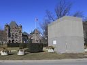 A Sir John A. Macdonald statue is boarded up on Friday March 5, 2021, after being vandalized during a protest at Queen's Park on Aug. 31, 2020. It now has three plaques on it explaining why it is boarded up and what might be done in the future.