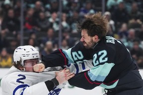 Toronto Maple Leafs defenceman Simon Benoit, left, gets punched by Seattle Kraken right wing Oliver Bjorkstrand, right, as they fight during the second period of an NHL hockey game Thursday, Feb. 6, 2025, in Seattle. (AP Photo/Lindsey Wasson)