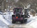 A snowplow tries to clear a path through buried cars and piles of snow on Cornell Avenue, north of Kingston Road. and west of Worden Avenue on Monday, February 17, 2025 in Scarborough.