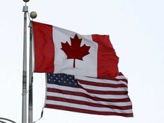 A Canadian flag flies next to the American one at the Lewiston-Queenston border crossing bridge on Feb. 4, 2025 in Niagara Falls, Canada.