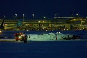 A Delta airlines plane sits on its roof after crashing upon landing at Toronto Pearson Airport in Toronto, Ontario, on Feb. 17, 2025.