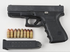 A weapon and ammunition seized in an armed robbery investigation.