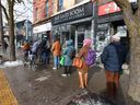People form a queue outside the Fort York Food Bank on College St. in the Kensington Market area of downtown Toronto on Feb.4, 2025. (Jack Boland, Toronto Sun)