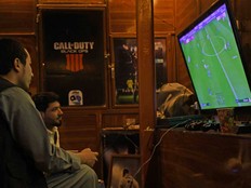 Afghan men play soccer on PlayStation 4 in Pul-e-Khumri of Baghlan province on Oct. 2, 2023.