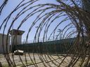 In this April 17, 2019, photo, reviewed by U.S. military officials, the control tower is seen through the razor wire inside the Camp VI detention facility in Guantanamo Bay Naval Base, Cuba.