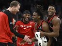 Toronto Raptors guard Ja'Kobe Walter, second from right, is congratulated by, from left, Jakob Poeltl, Immanuel Quickley and RJ Barrett.