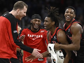 Toronto Raptors guard Ja'kobe Walter, second on the right, congratulations to Jakob Poeltl, Immanuel Quickley and RJ Barrett.