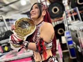 WWE superstar Iyo Sky celebrates after winning the WWE Women's Championship.