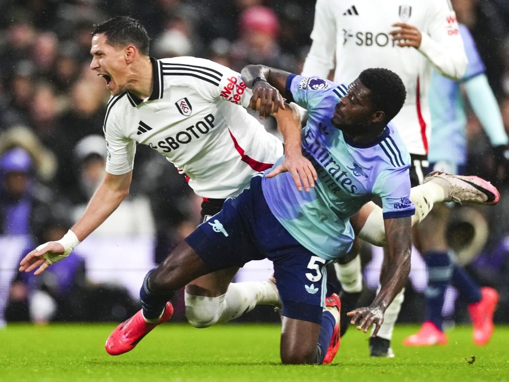 Fulham's Sasa Lukic challenges for the ball with Arsenal's Thomas Partey during a game last year.