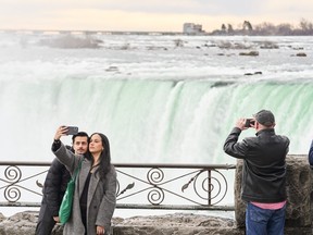 Visitors take pictures in front of Horseshoe Falls.