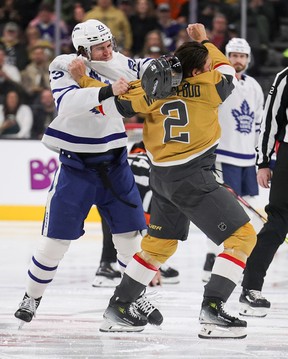 Matthew Knies #23 of the Toronto Maple Leafs and Zach Whitecloud #2 of the Vegas Golden Knights fight at the start of the first period of their game at T-Mobile Arena on March 05, 2025 in Las Vegas, Nevada. (Photo by Ethan Miller/Getty Images)