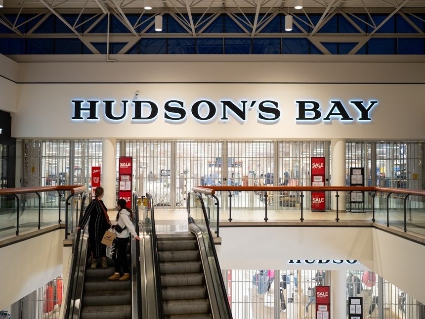  Shoppers on an elevator look back at a closed Hudson’s Bay store in a mall on March 20, 2025 in Hamilton, Ont.